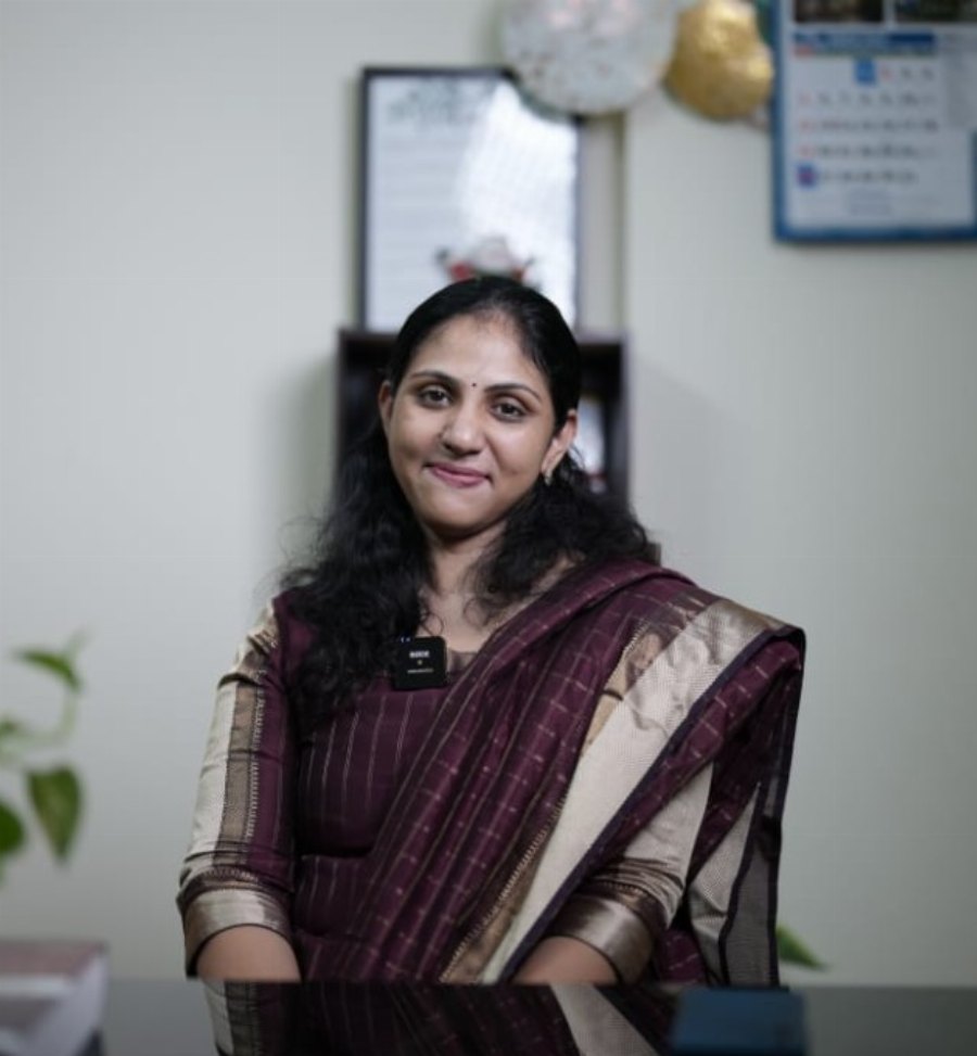Portrait of Dr. Navya Mary Kurian in clinic attire